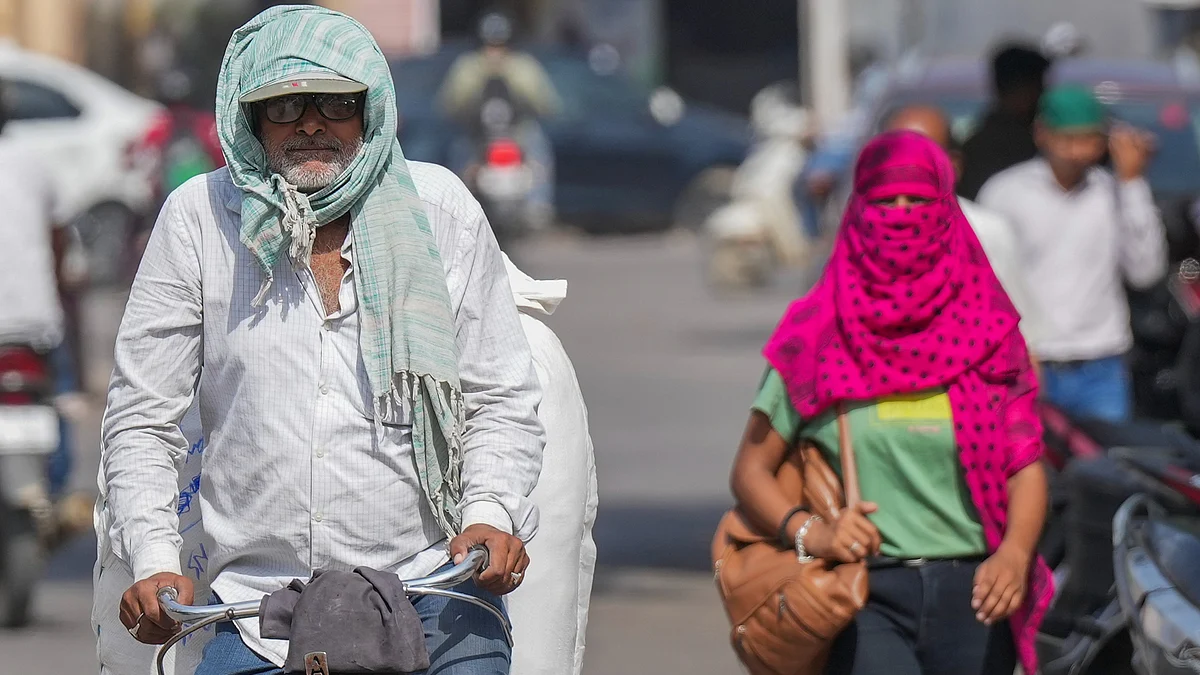 People cover themselves against sun during a heatwave in Varanasi 
