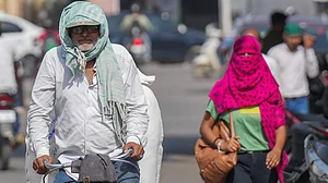 People cover themselves against sun during a heatwave in Varanasi