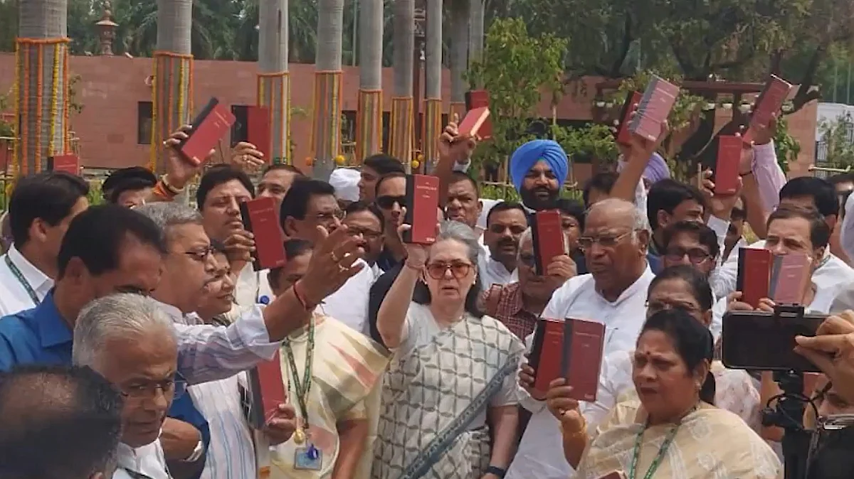 Screengrab of INDIA bloc MPs holding copies of the Constitution in their hands from @kharge/X