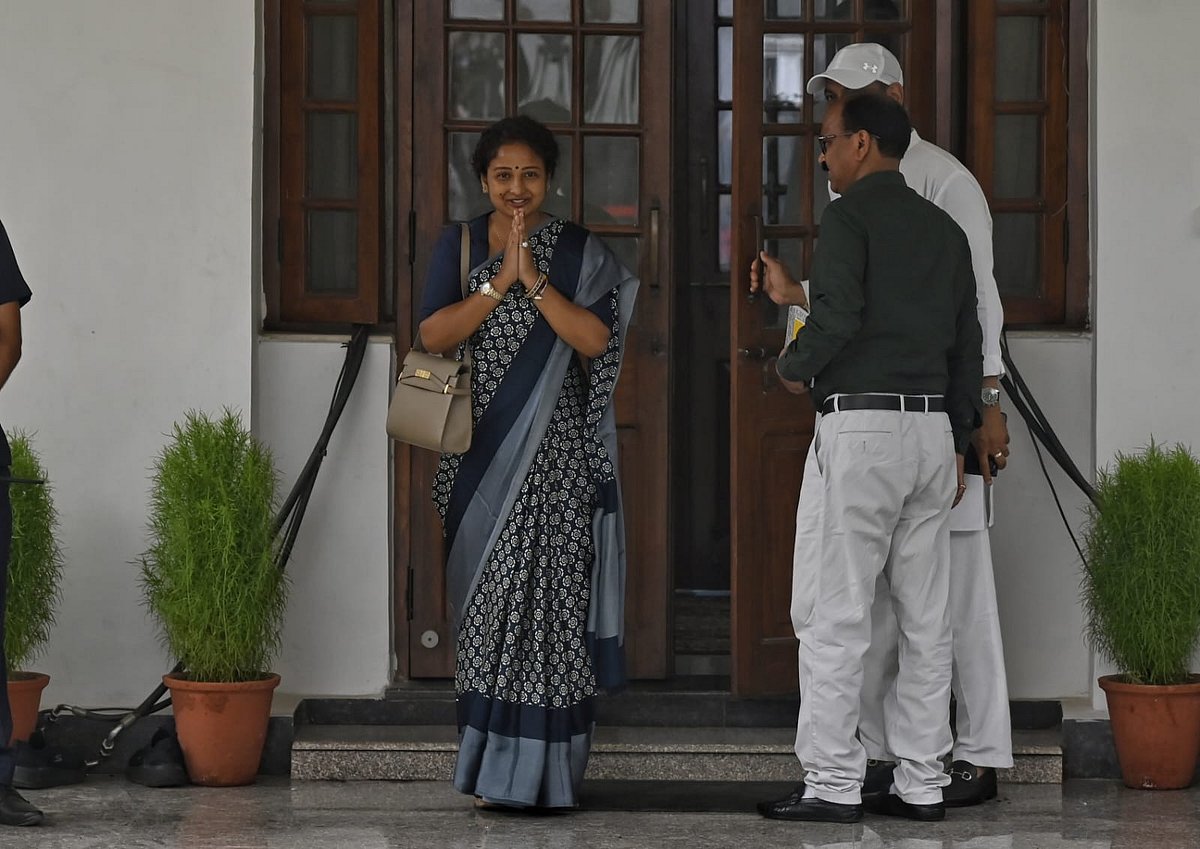Supriya Sule of the Nationalist Congress Party (SP) does a namaste