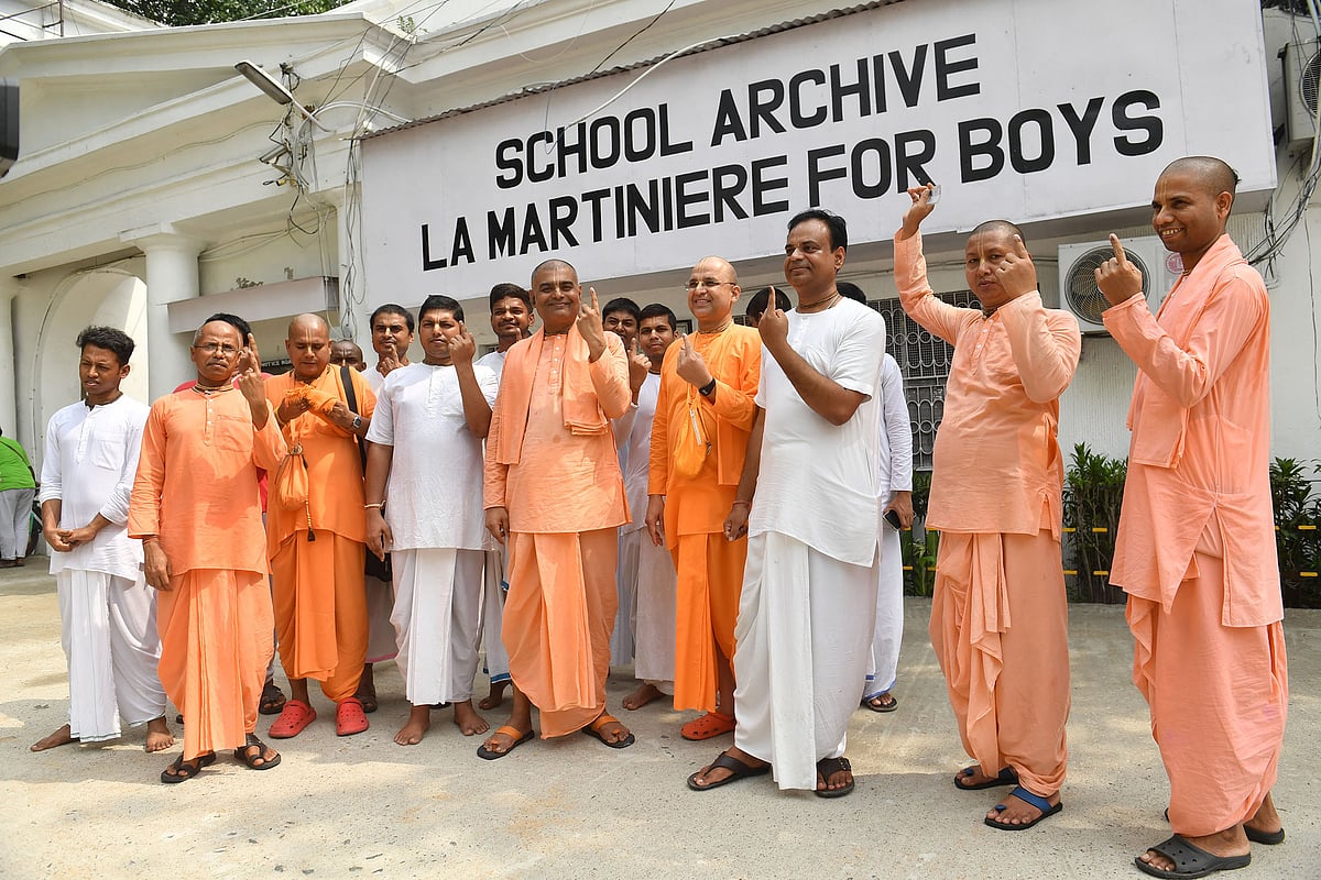 Monks from ISKCON pose after voting in Kolkata