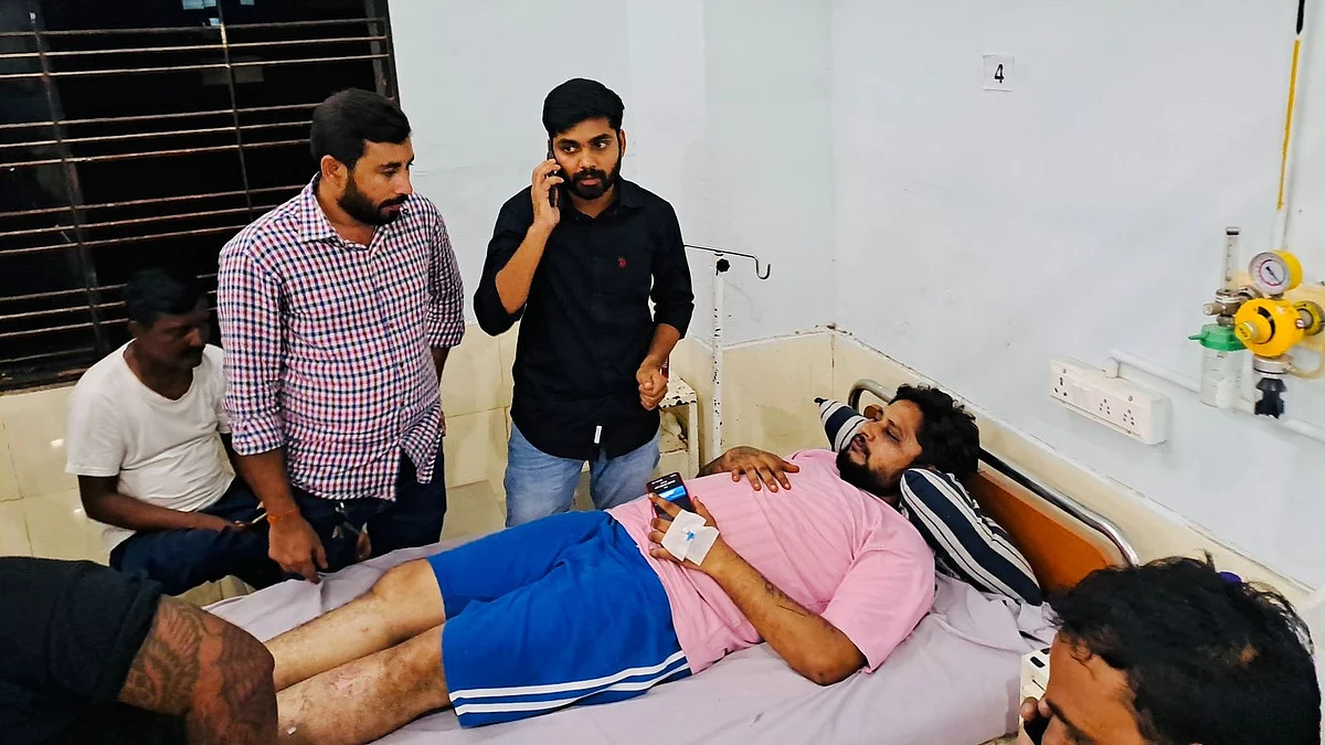 Sanjay Solanki (in hospital bed) after his alleged kidnapping and assault (photo courtesy @NSUIGujarat/X)