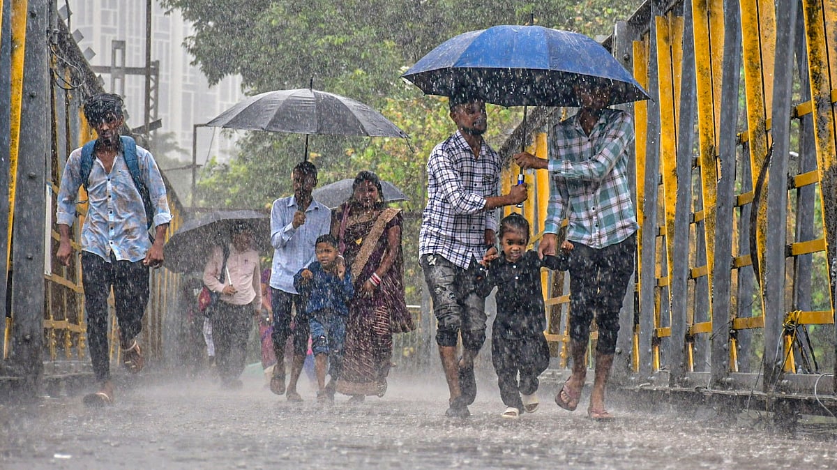 Pedestrians protect themselves from rain in Mumbai