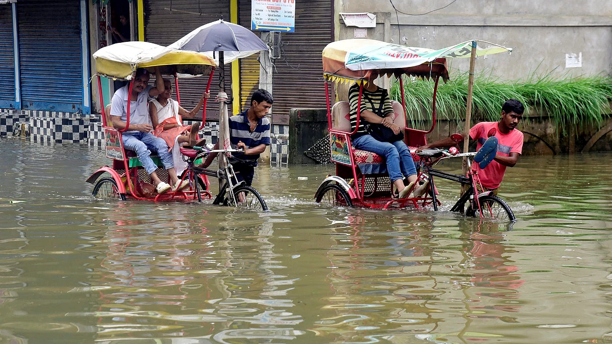 Rickshaws wade through a waterlogged street in Nainital on 6 June (photo: PTI)