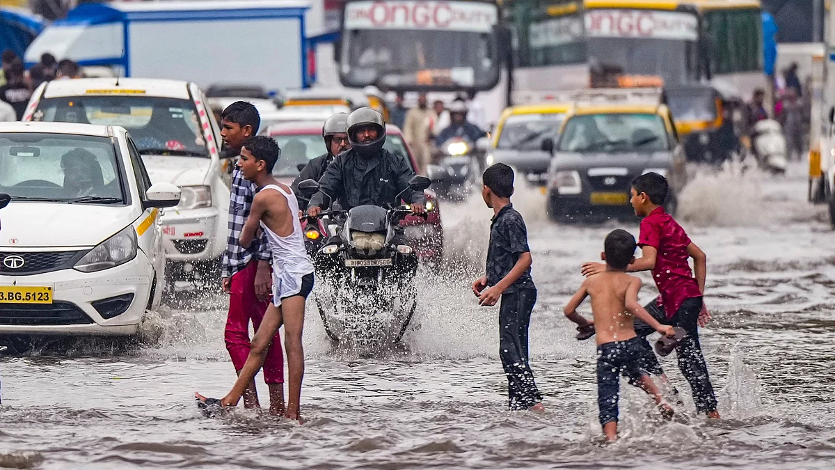 Children enjoy in rain in Mumbai on 8 July (photo: PTI)