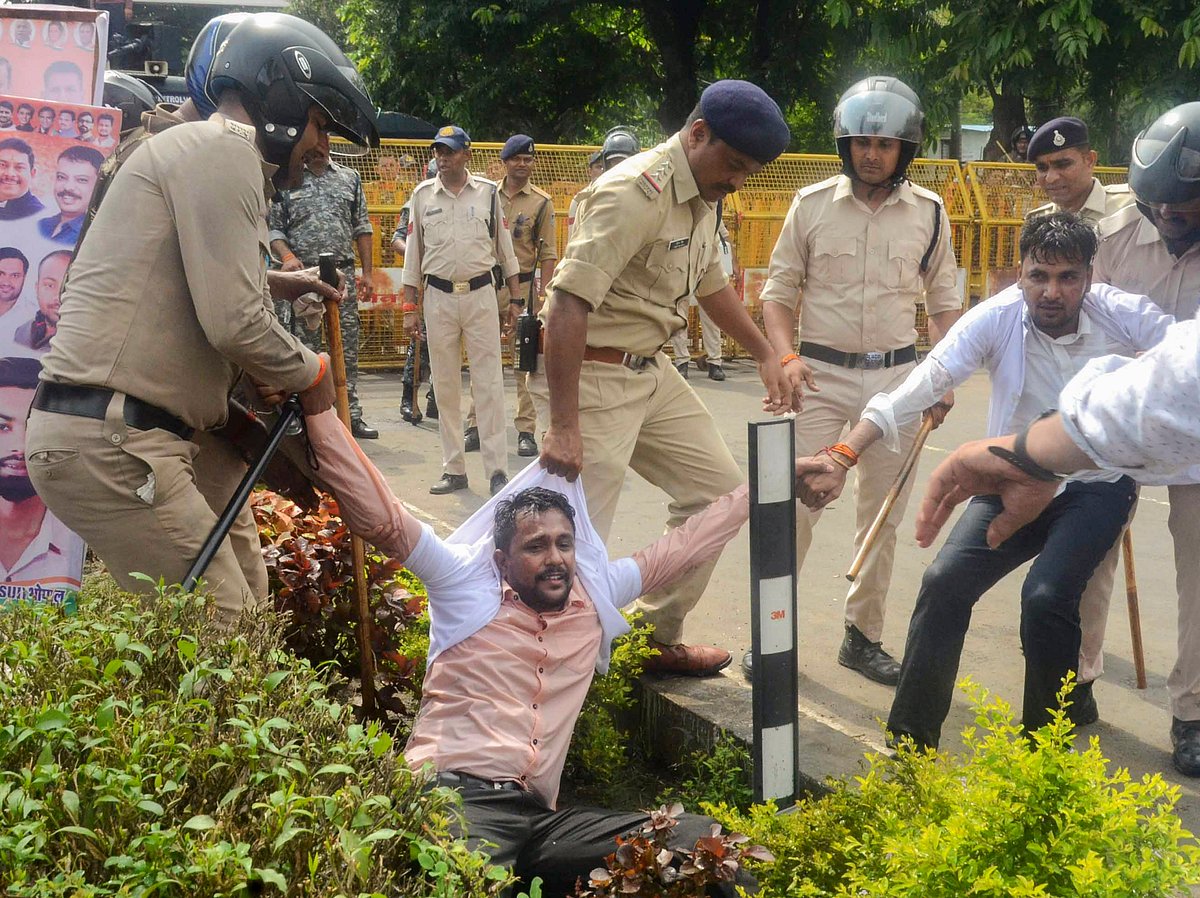 Police detain an activist in Bhopal