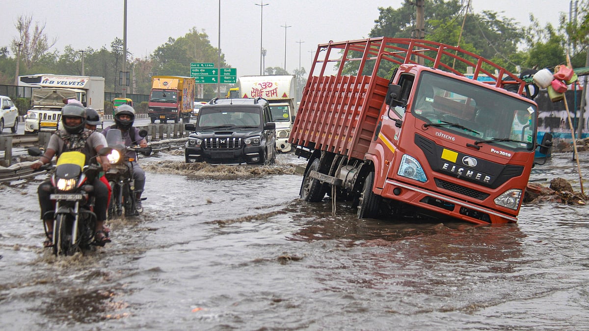 Vehicles move through a waterlogged street in Gurugram on 28 June (photo: PTI)