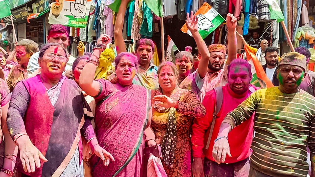 Congress workers celebrate party's victory in Chamoli on 13 July (photo: PTI)
