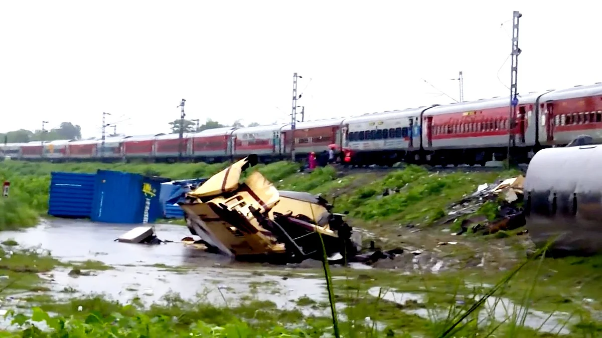 An upline train runs through the accident area a day after the collision (photo: PTI)