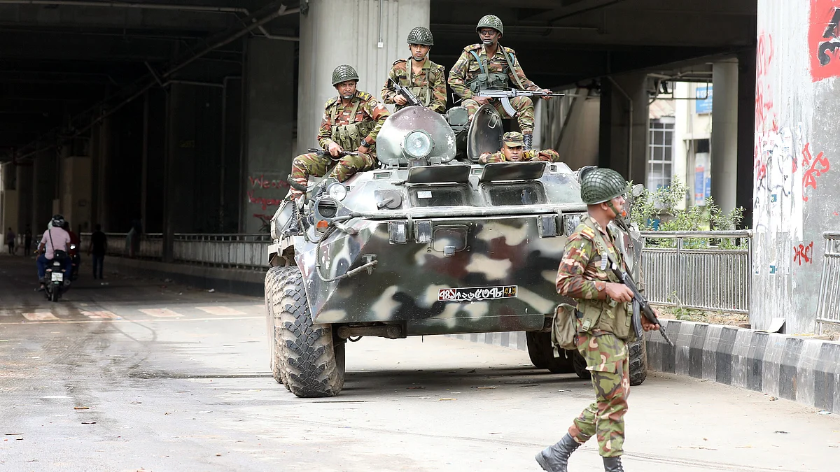 Bangladeshi soldiers patrol Dhaka after the government imposed a new curfew on 5 Aug