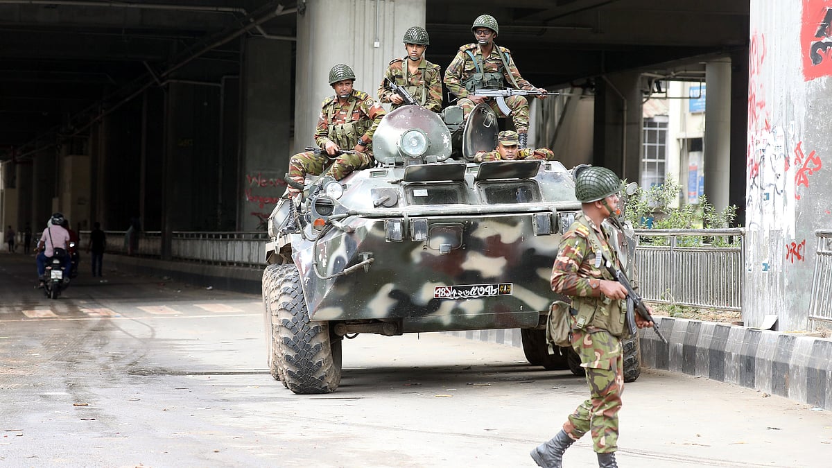Bangladeshi soldiers patrol Dhaka after the government imposed a new curfew on 5 Aug