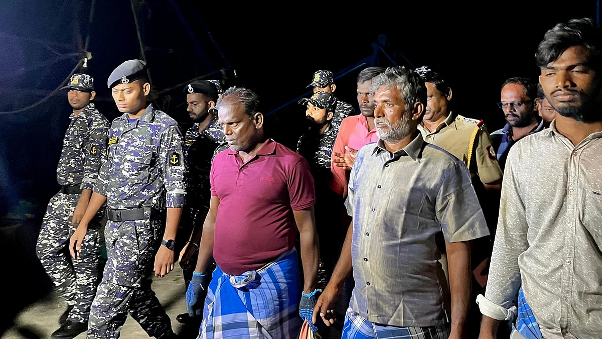 Indian Navy personnel with the fishermen apprehended in Sri Lanka (photo: PTI)