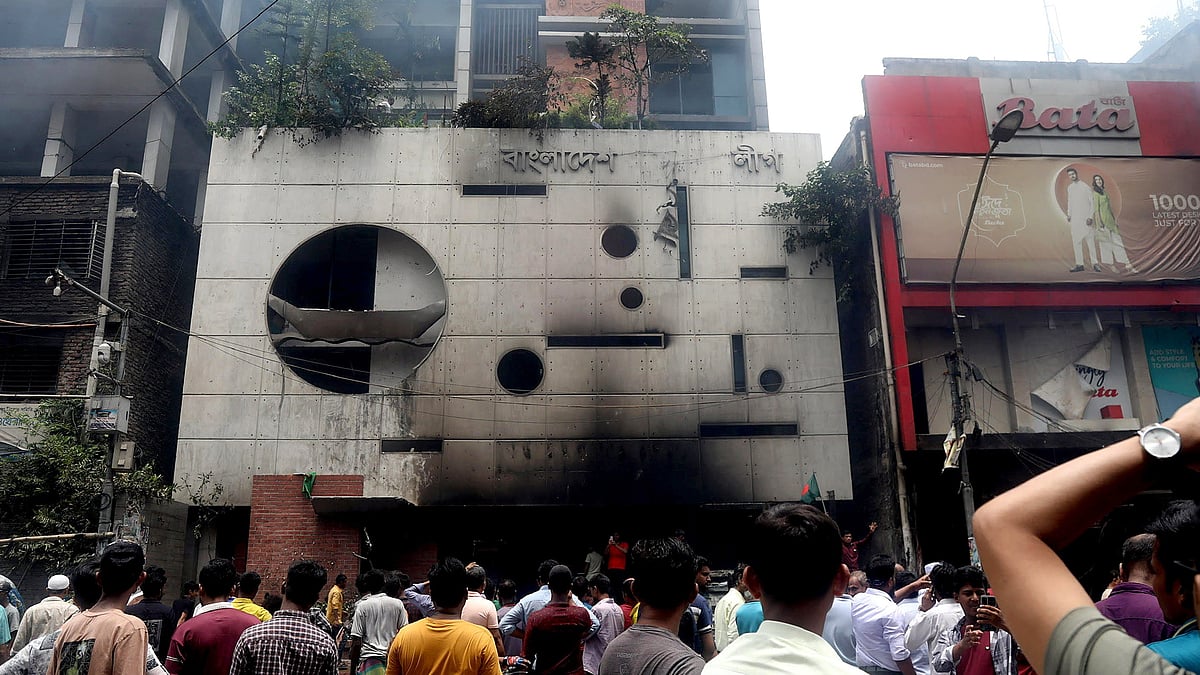 People gather in front of the ransacked Awami League's central office 