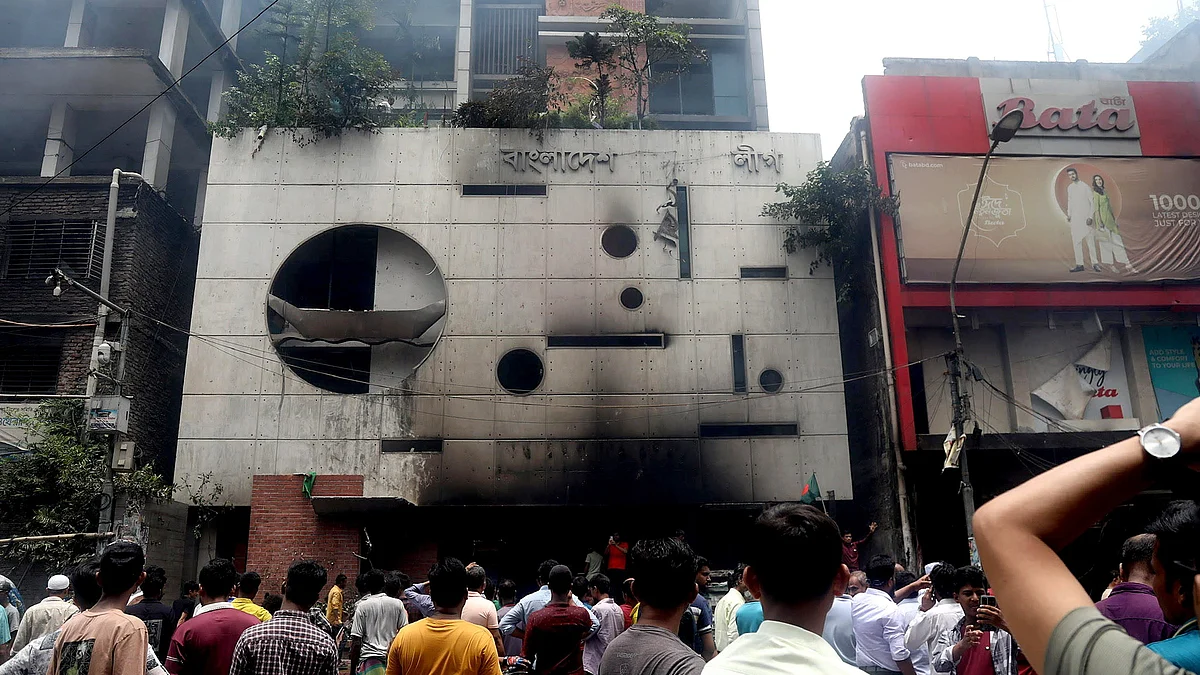 People gather in front of the ransacked Awami League's central office 