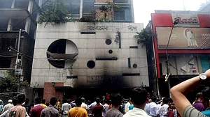 People gather in front of the ransacked Awami League's central office