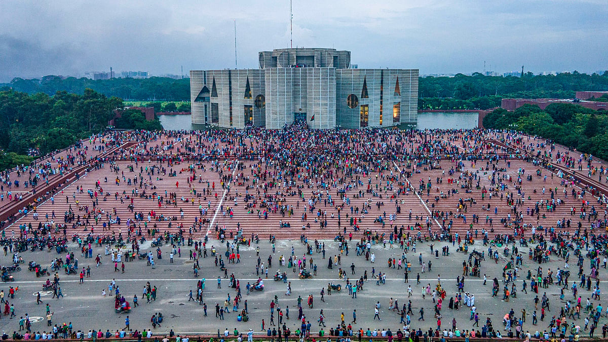 A photo taken with a drone shows people gather around at the Bangladesh Parliament House in Dhaka