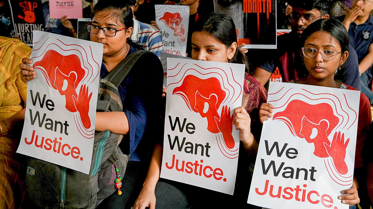 Kolkata: Junior doctors and nursing staff hold placards during an ongoing protest