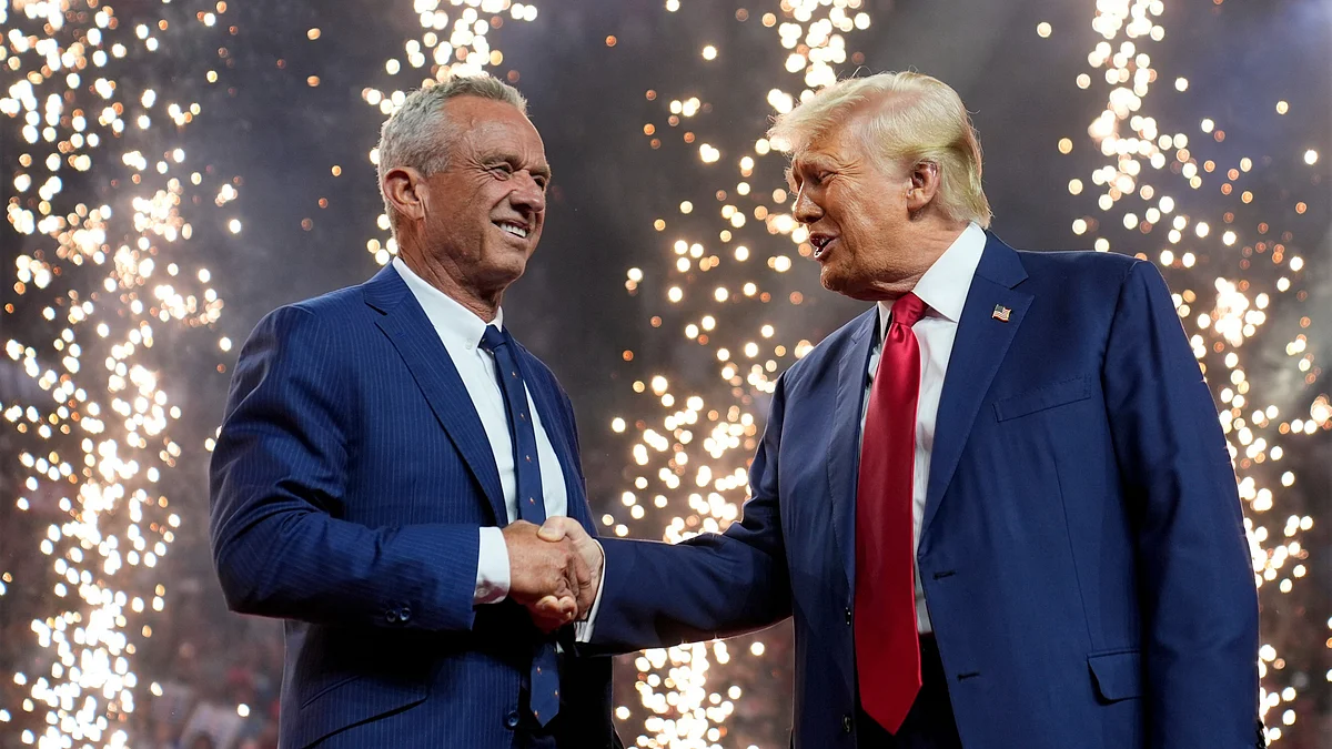 Donald Trump shakes hands with Robert F. Kennedy Jr at a campaign rally