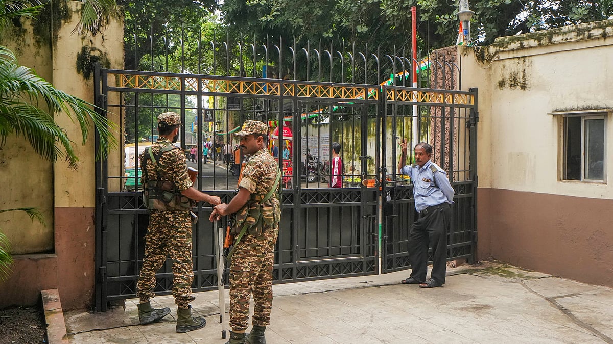 Security guards on duty during the raid at RG Kar Medical College's ex-superintendent's premises