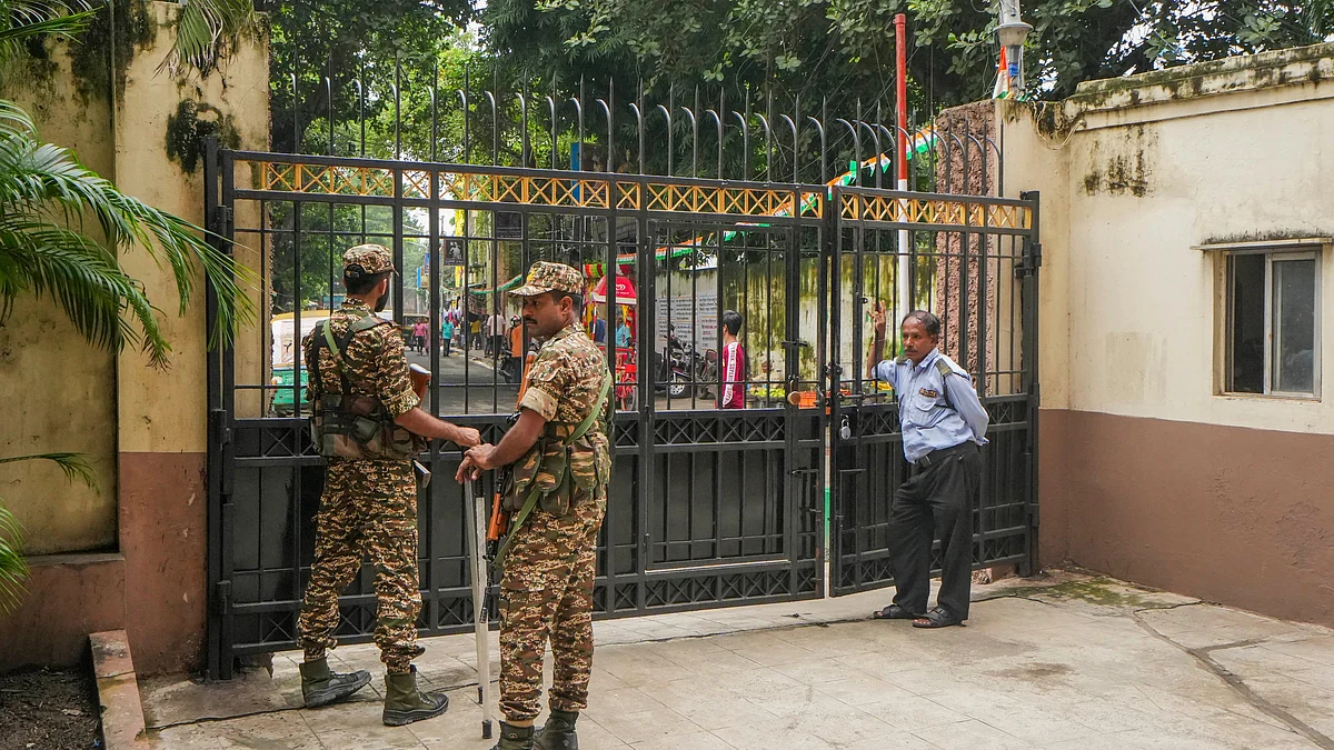 Security guards on duty during the raid at RG Kar Medical College's ex-superintendent's premises