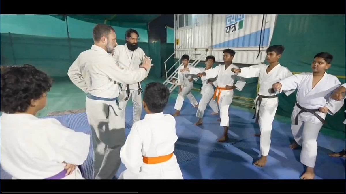 Rahul Gandhi works on young martial arts students' stance in the dojo