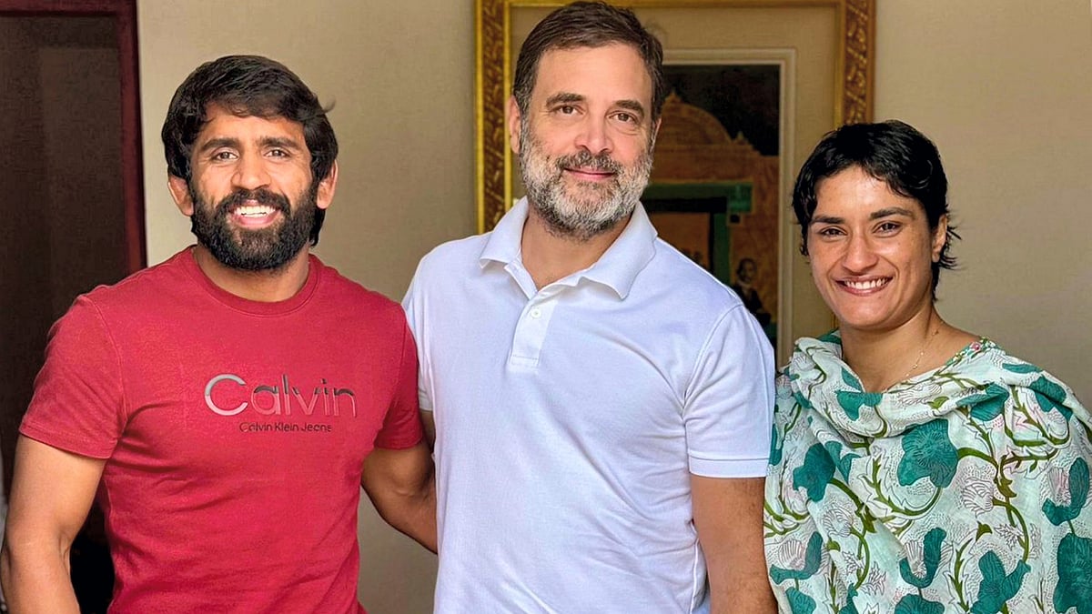 Rahul Gandhi with Vinesh Phogat and Bajrang Punia in New Delhi on 4 September (photo: PTI)