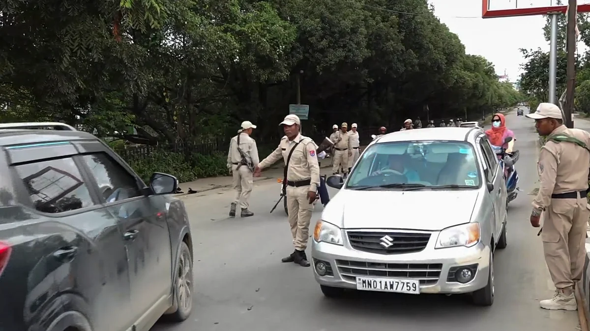 Imphal: Police personnel check vehicles
