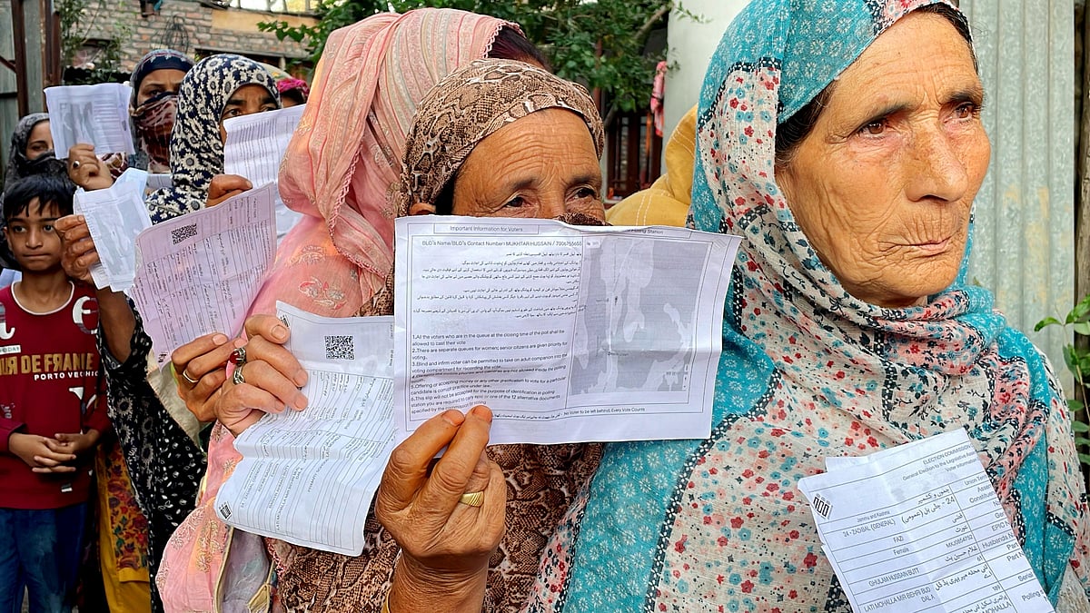 Srinagar : Voters stand in a queue to cast their votes at a polling station