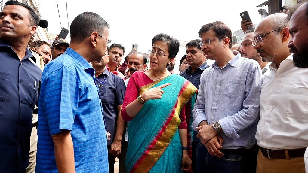 New Delhi CM Atishi (centre) has an animated chat with former CM Arvind Kejriwal (checked shirt) 
