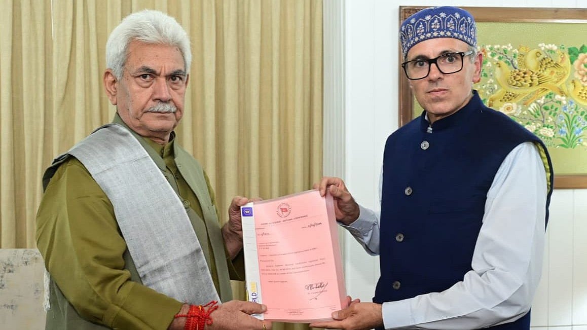 CM designate Omar Abdullah (right) presents his letters of support to J&K governor Manoj Sinha