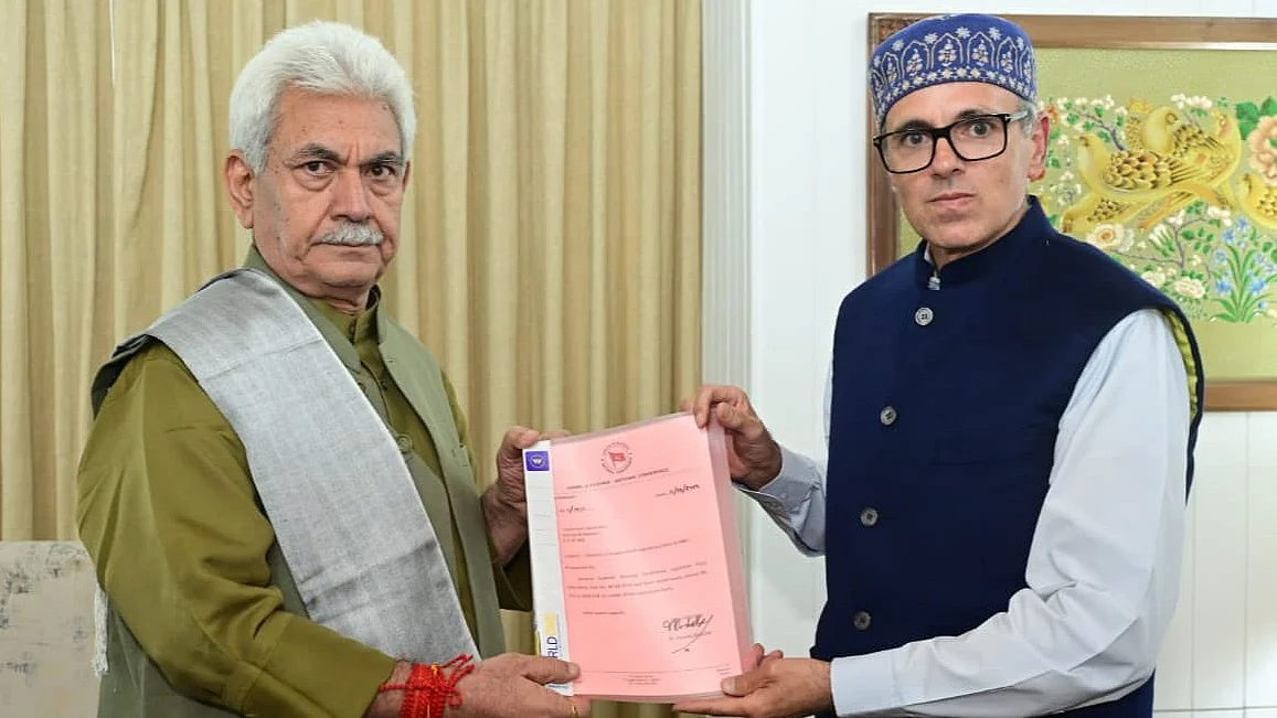 CM designate Omar Abdullah (right) presents his letters of support to J&K governor Manoj Sinha