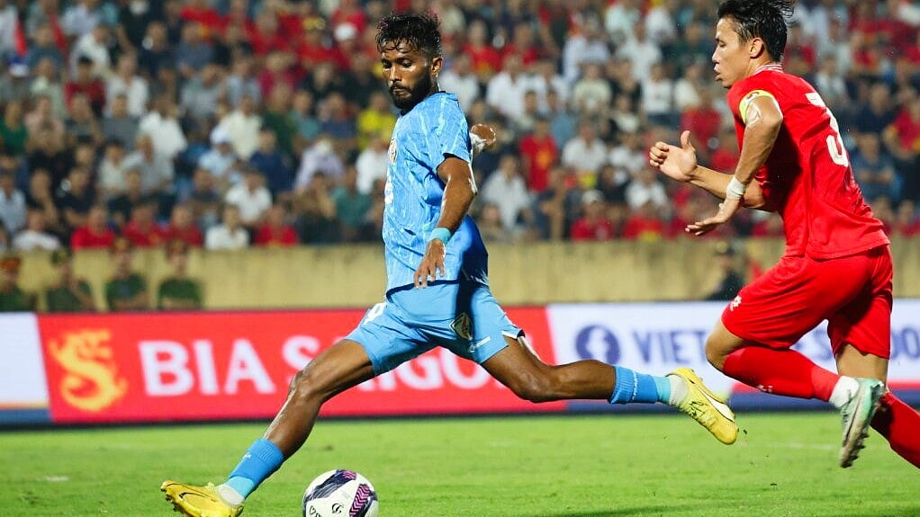 India winger Farukh Chowdhury tries to beat a Vietnam rival during their friendly on Saturday