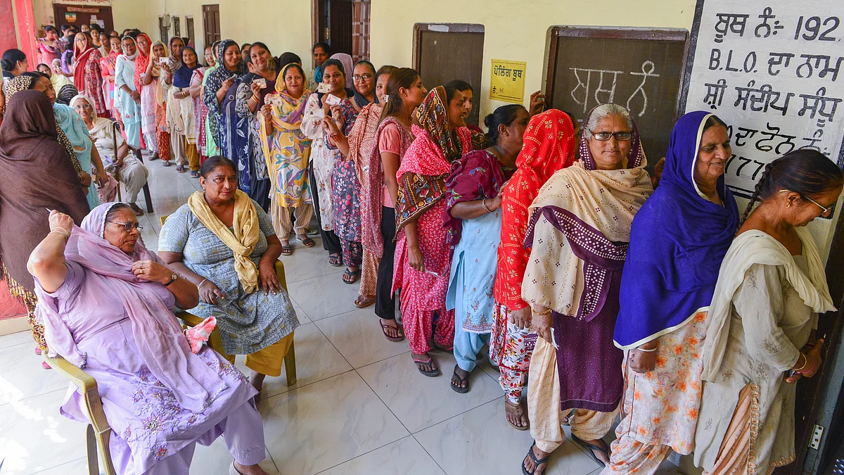 Voters wait to cast their votes for the Punjab gram panchayat elections in Attari