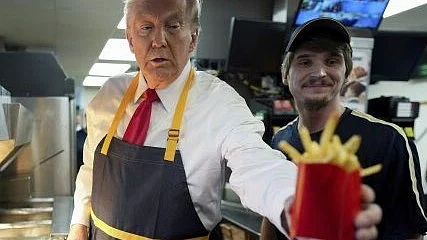 Presidential candidate Donald Trump serves up fries at McDonald's as part of his campaign