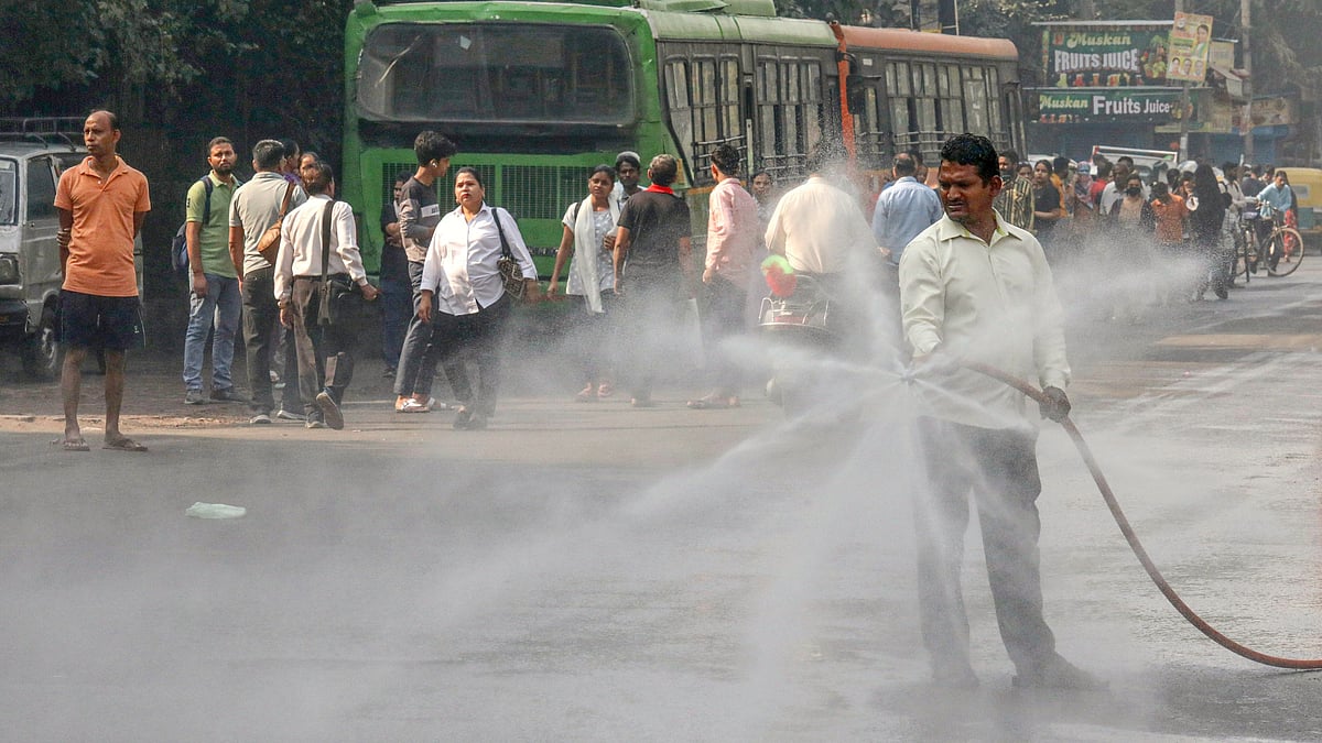 Water being sprinkled to curb air pollution at Jahangirpuri, New Delhi