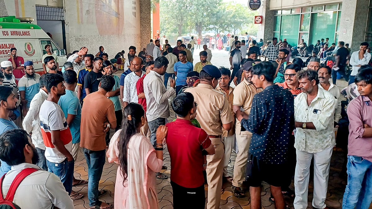 Relatives of injured passengers wait outside a hospital in Mumbai on 27 October (photo: PTI)