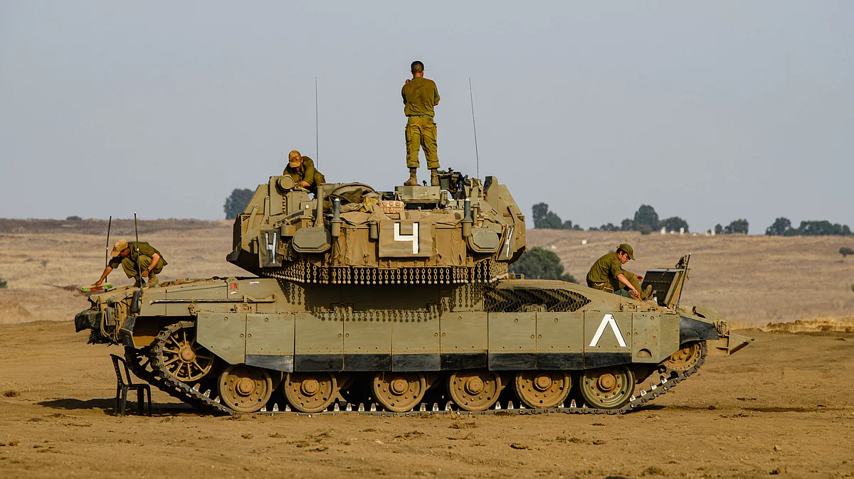 File image of Israeli soldiers atop tanks near the Blue Line