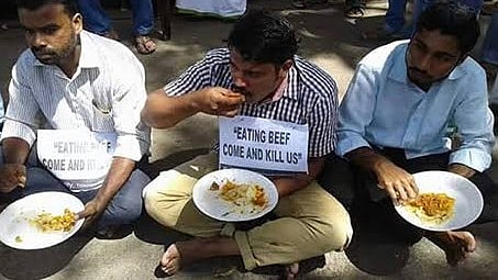 Protestors wear 'Eating beef. Come kill us' cards. Anti-beef rhetoric often uses anti-Muslim language