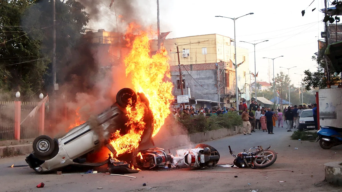 Flames billow out of vehicles in Imphal on 16 November (photo: PTI)