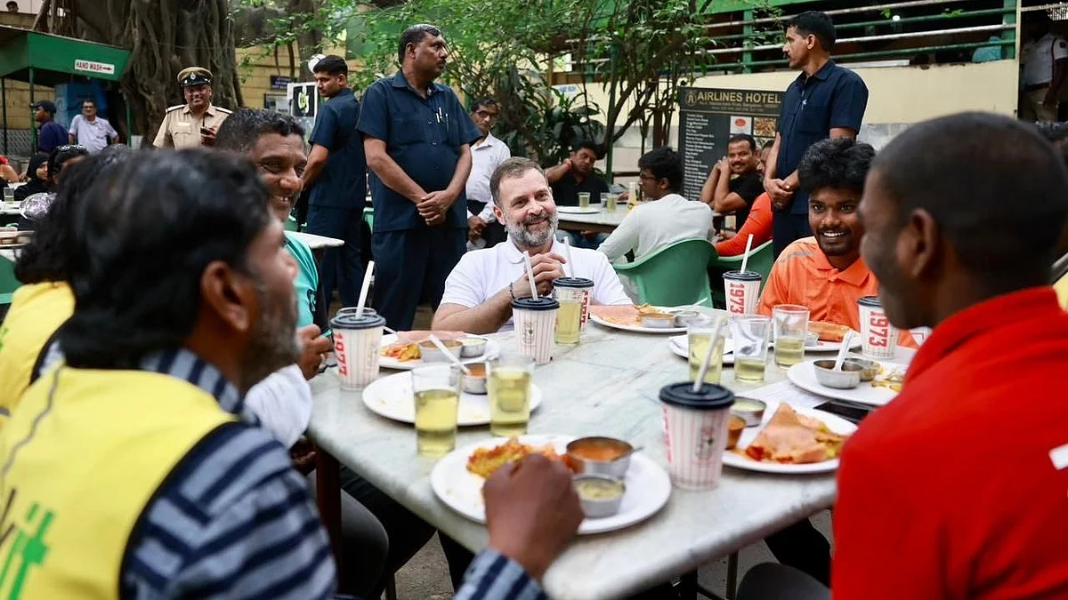 Rahul Gandhi (white shirt, centre) shares a meal with gig workers with various companies 