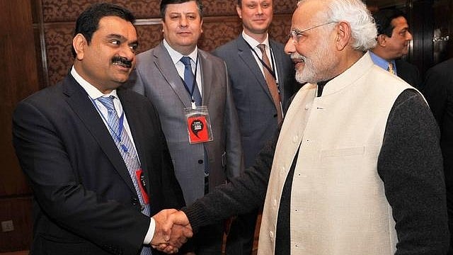 Gautam Adani (left) shares a warm handshake with PM Modi