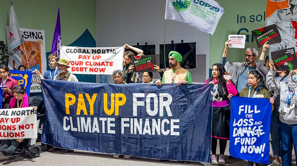 Civil society members stage a silent march at COP29, Baku, 23 Nov. 2024 (Photo: PTI)
