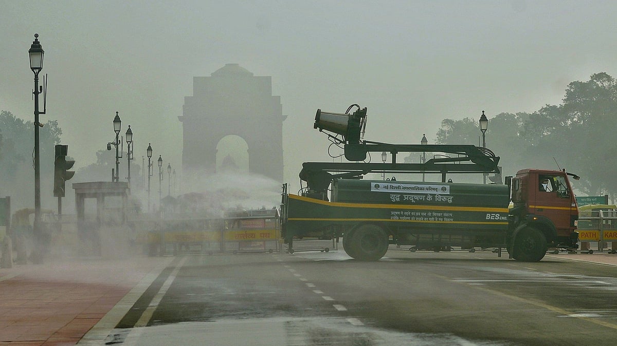 An anti-smog vehicle sprinkles water on Kartavya Path near India Gate in Delhi