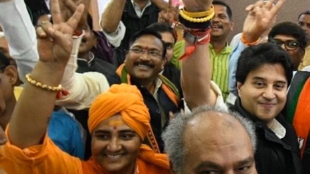 Sadhvi Pragya Singh Thakur (in saffron) in a jubilant mood, flashing a 'V' alongside BJP colleagues 