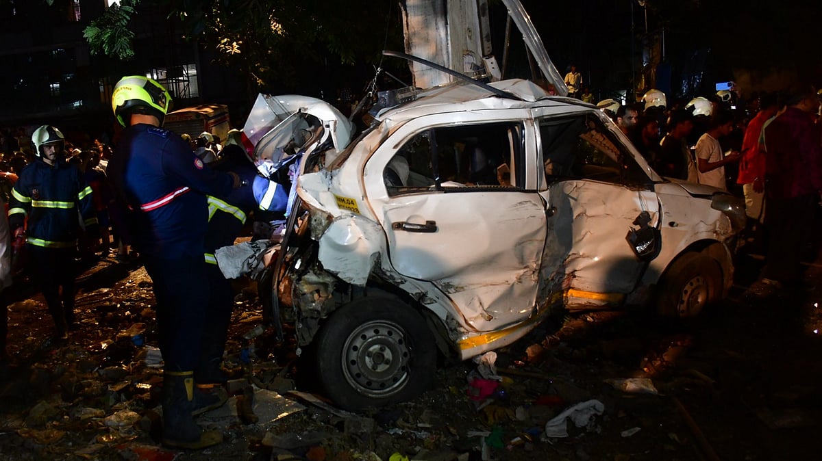 A damaged car being checked in Mumbai (photo: PTI)