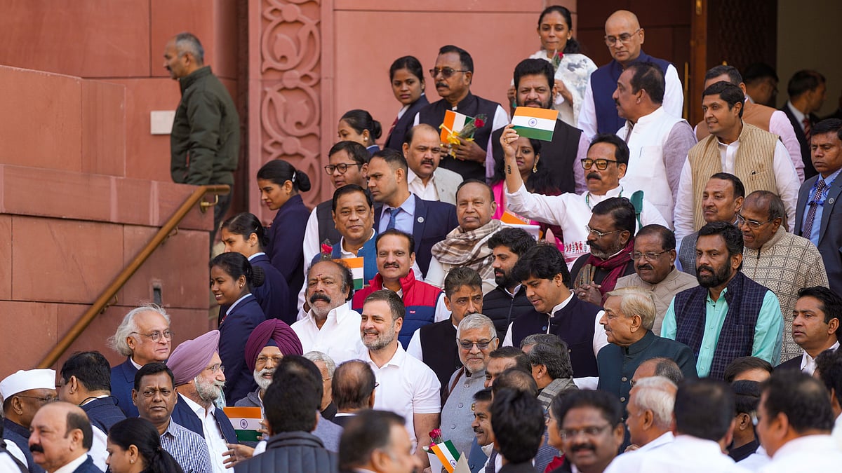 Opposition MPs greet colleagues on the treasury benches with a tricolour and a red rose
