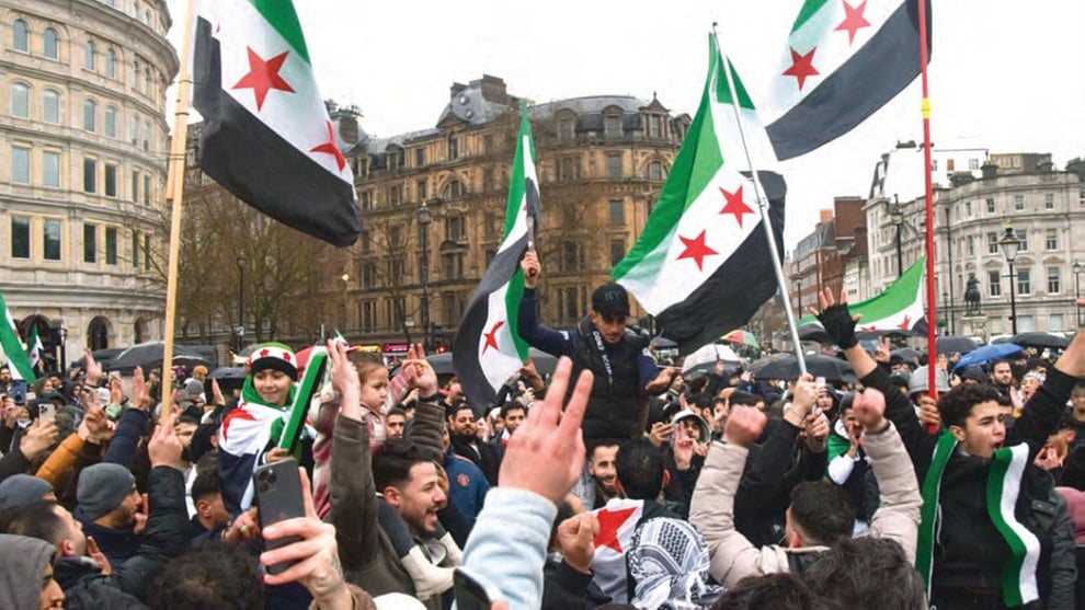 Syrians in London celebrate the ouster of Bashar al-Assad, 8 Dec. 2024 (Getty)