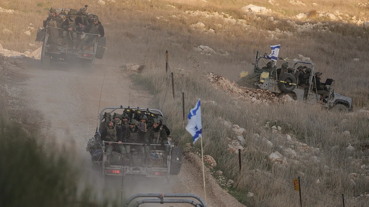 Israeli soldiers cross security fence in the town of Majdal Shams on 15 December (photo: PTI)