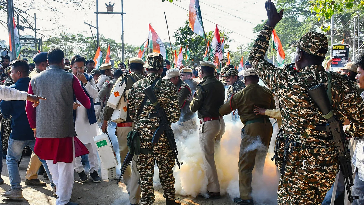 Police personnel use teargas during the Congress protest in Guwahati (photo: PTI)