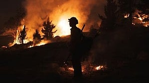 Firefighters still battling California wildfires as winds fade